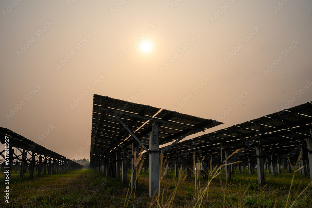 Shot of ecology solar power station panels in a field during sunset. 