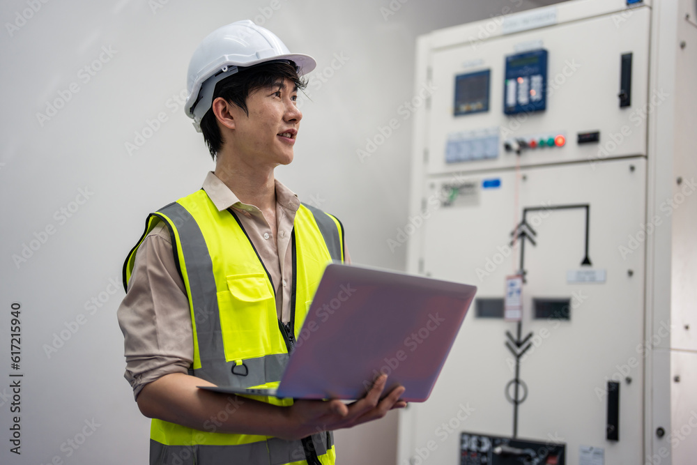 Asian attractive man industrial worker working in manufacturing plant. 