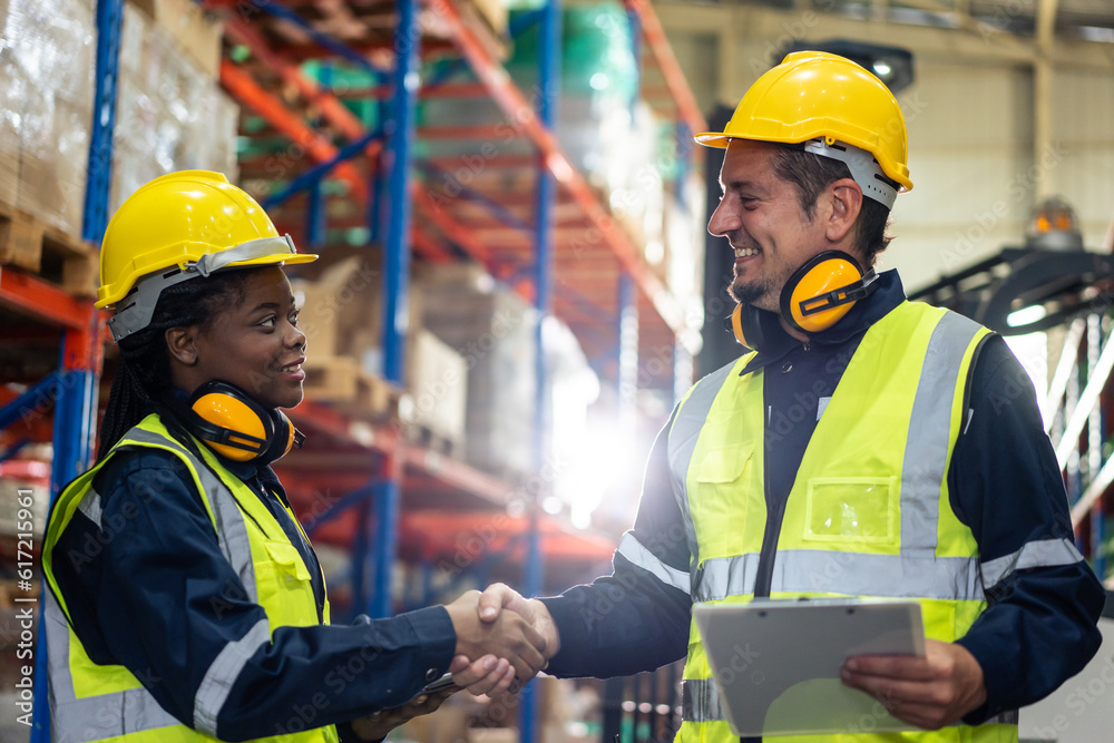 Diverse industrial worker team working in manufacturing plant together. 