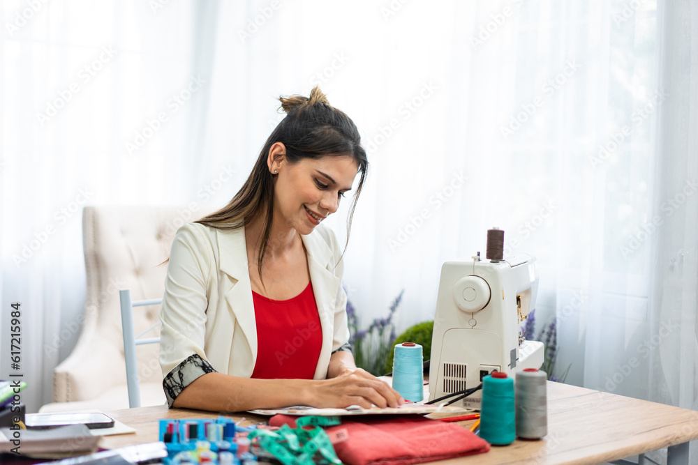 Caucasian women fashion designer design clothes in tailoring atelier. 