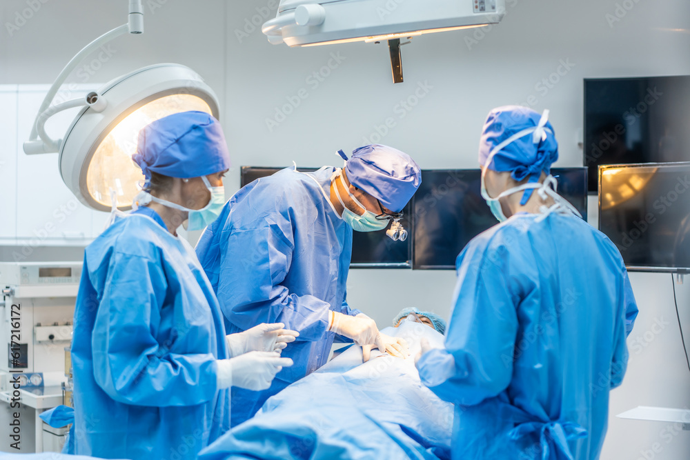 Professional doctors performing surgical operation in operating room. 