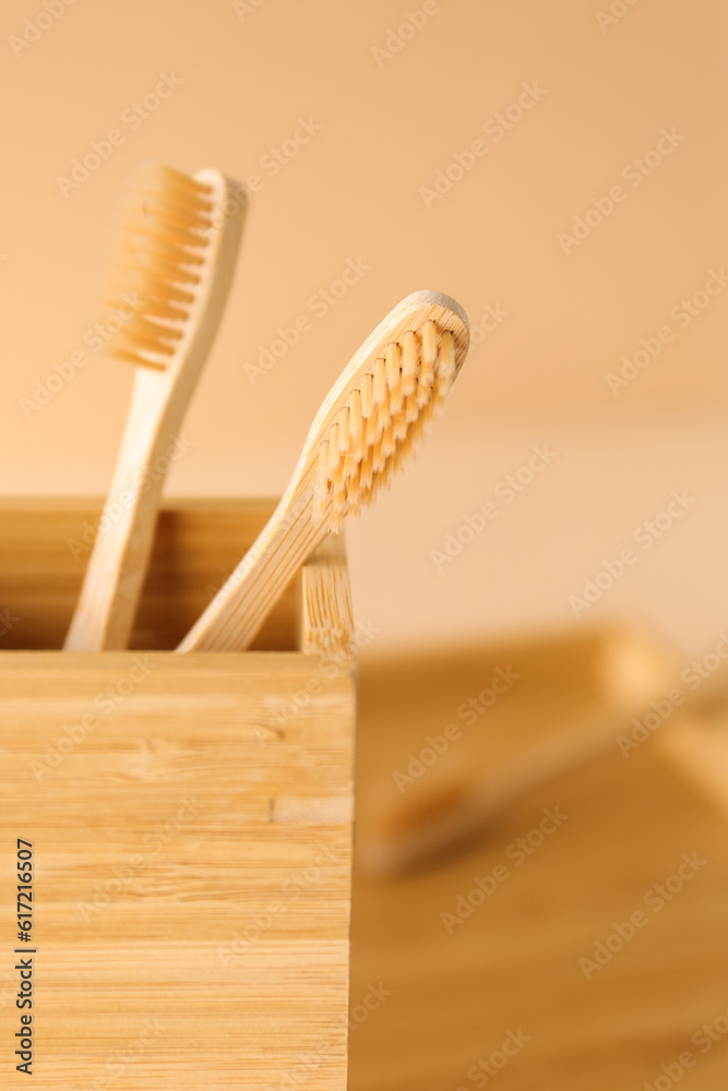 Bamboo tooth brushes in holder on table, closeup