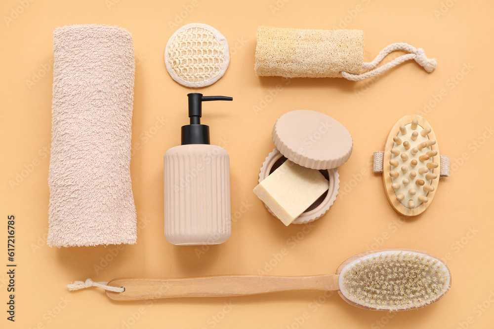 Set of bath supplies with massage brushes on color background