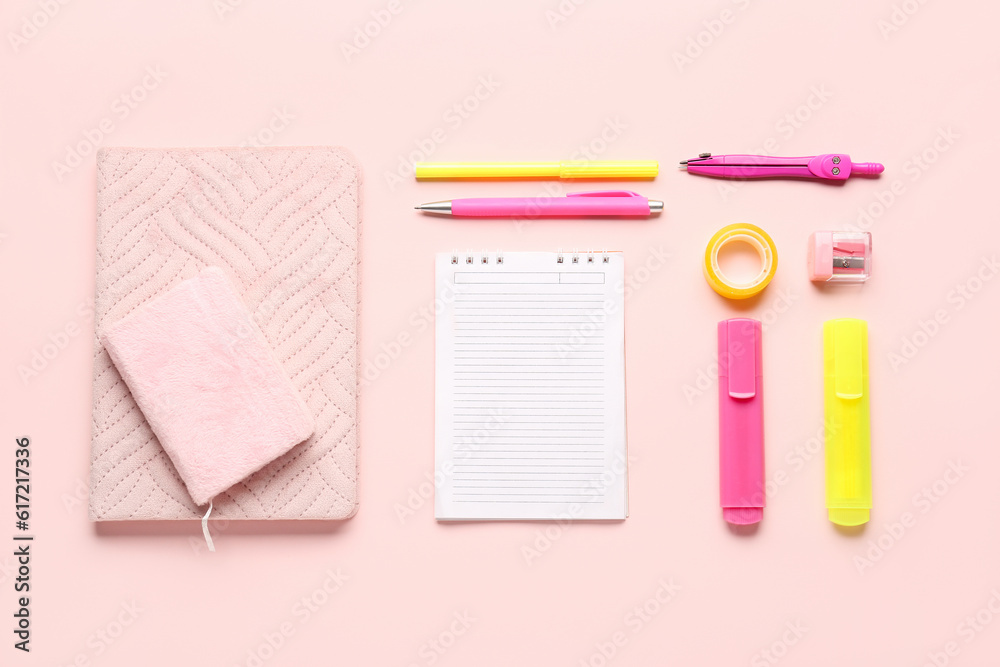 Notebooks with different school stationery on pink background