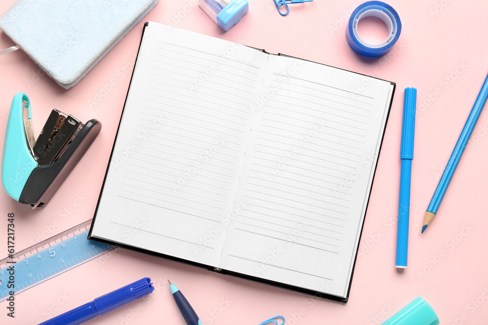 Notebooks with different school stationery on pink background