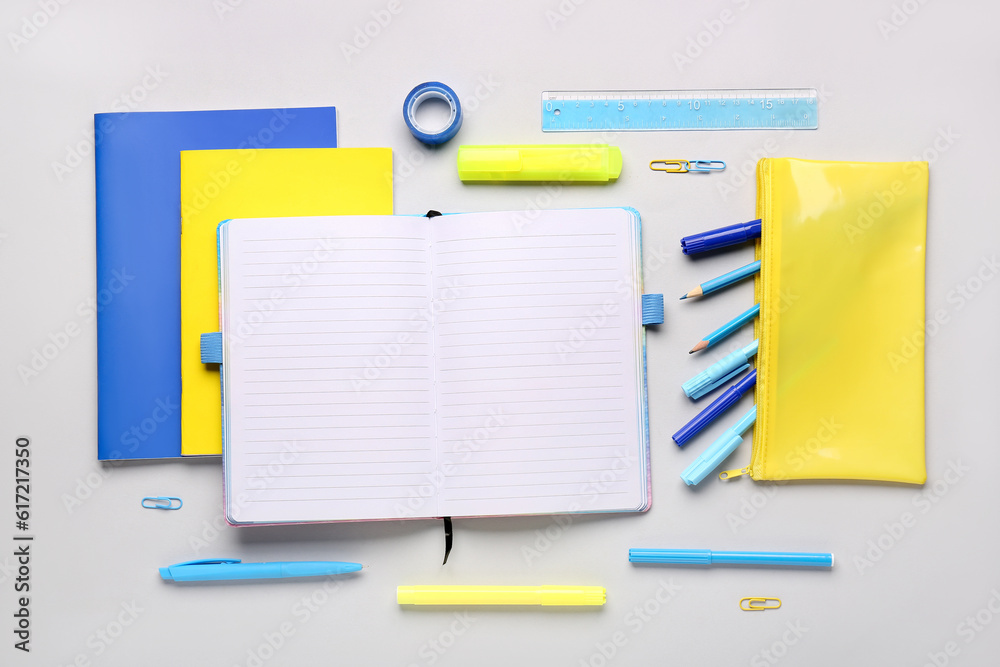 Notebooks with pencil case and  different school stationery on white background