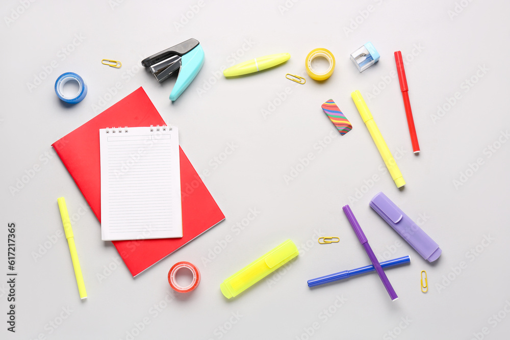 Notebooks with different school stationery on white background