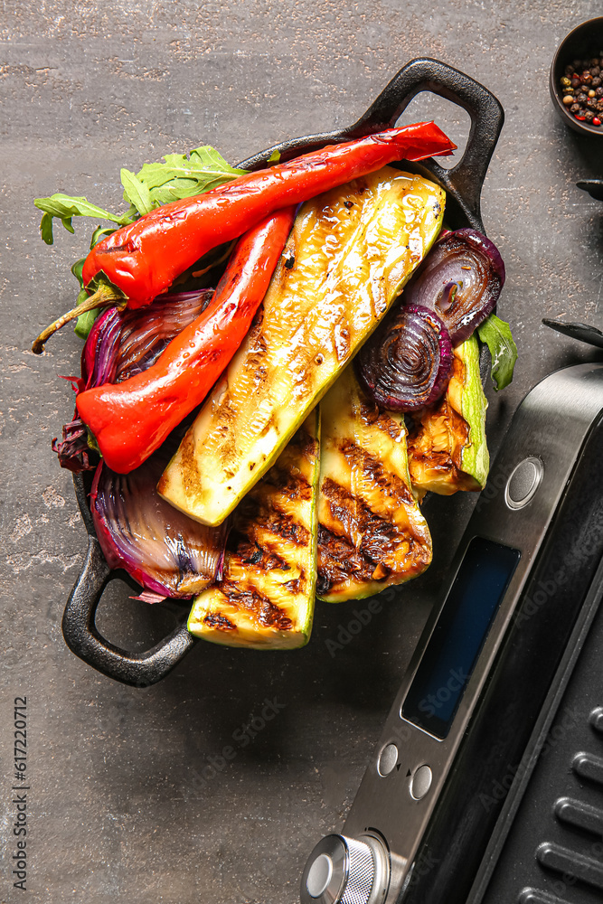 Baking dish with tasty grilled vegetables on dark background