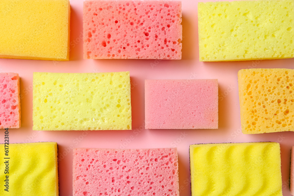 Many different sponges on pink background