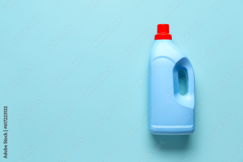 Bottle of detergent on blue background