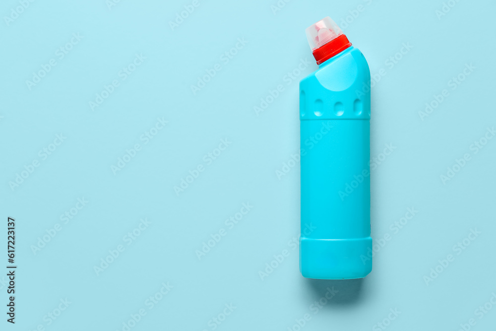 Bottle of detergent on blue background