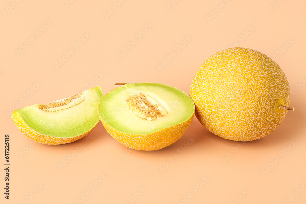 Sweet melon with pieces on orange background