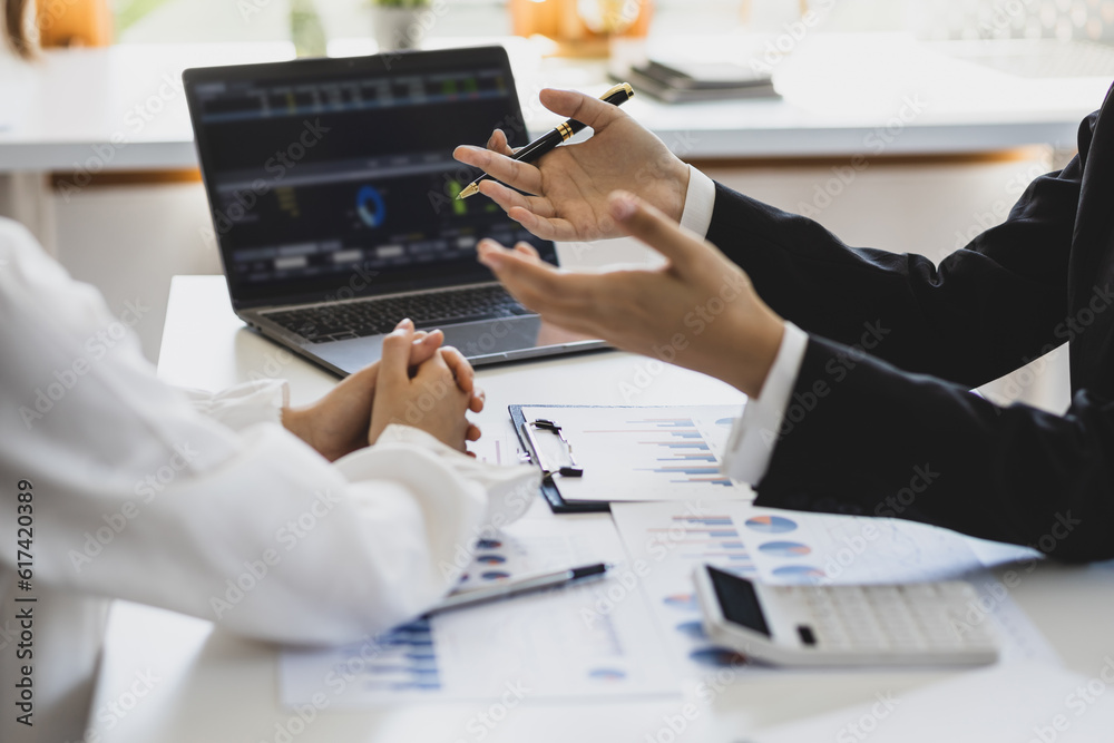 Financial advisor discussing business management planning with businesswoman in office.