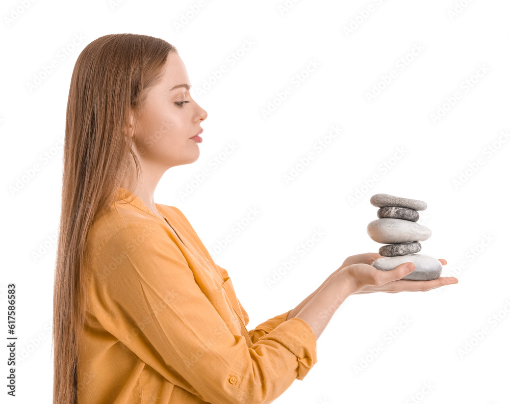 Young woman with spa stones on white background. Balance concept