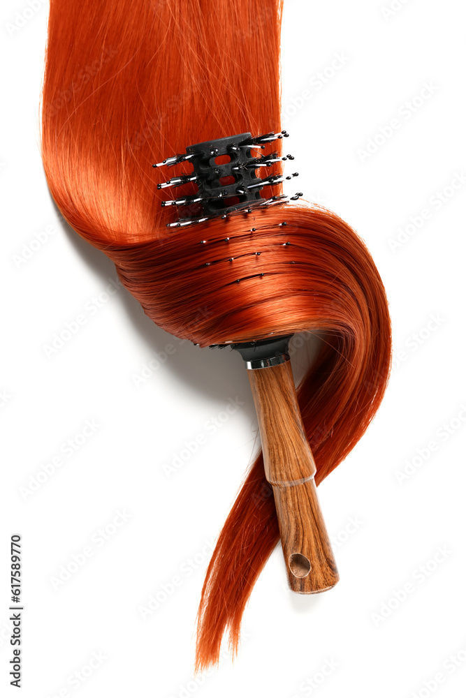 Ginger hair strand with brush on white background, closeup