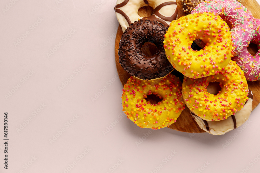 Board with sweet donuts on white background