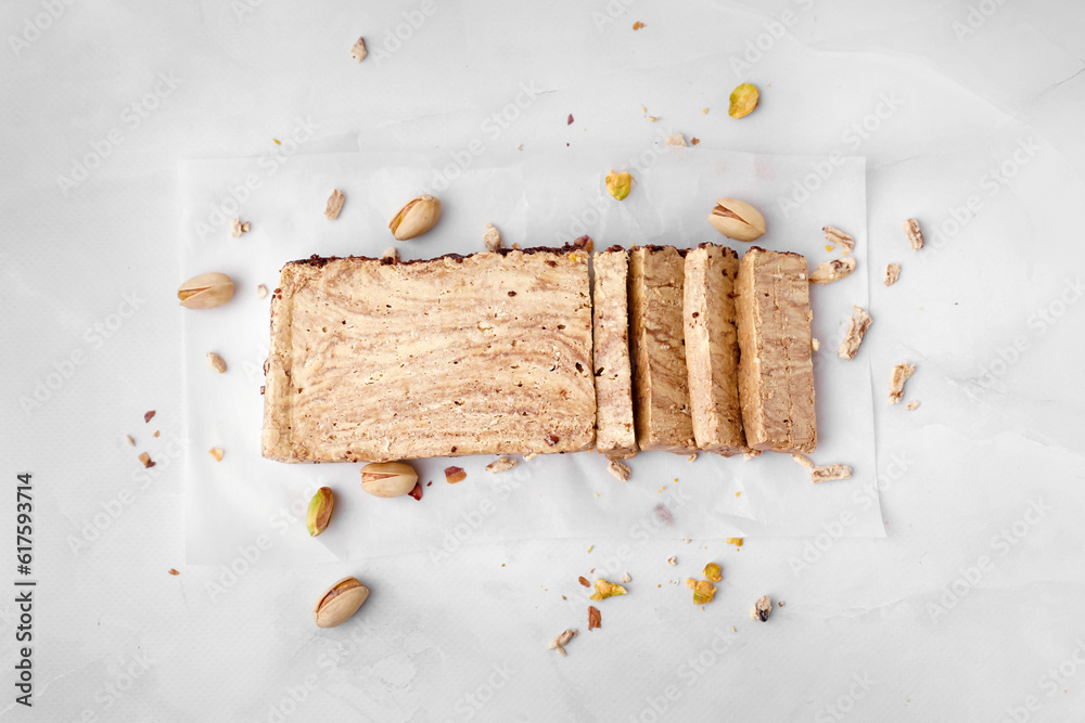 Pieces of tasty marble halva on light background