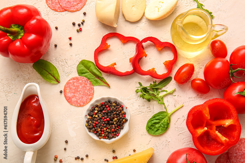 Different ingredients for preparing pizza on light background