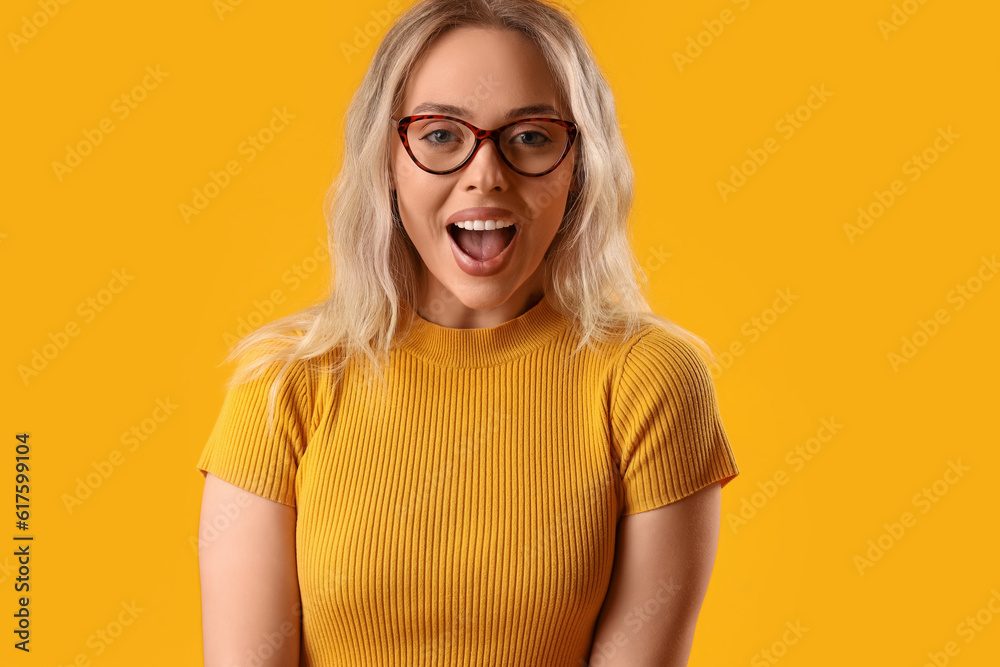 Young woman in stylish eyeglasses on orange background, closeup