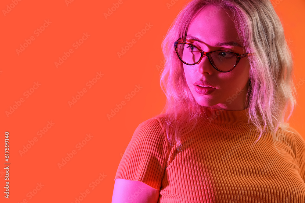 Young woman in stylish eyeglasses on color background, closeup