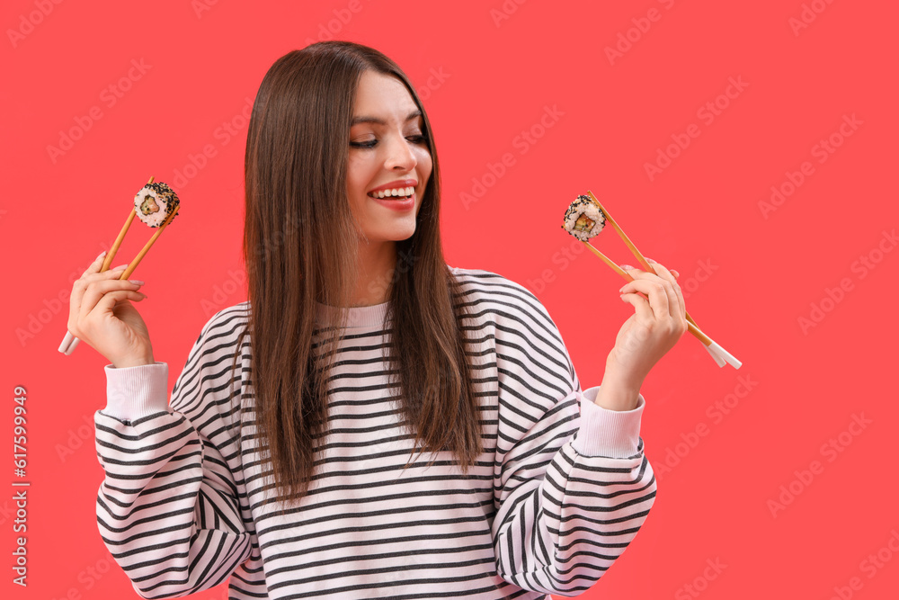 Young woman with sushi on red background