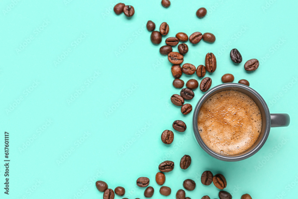 Cup of hot espresso and coffee beans on blue background