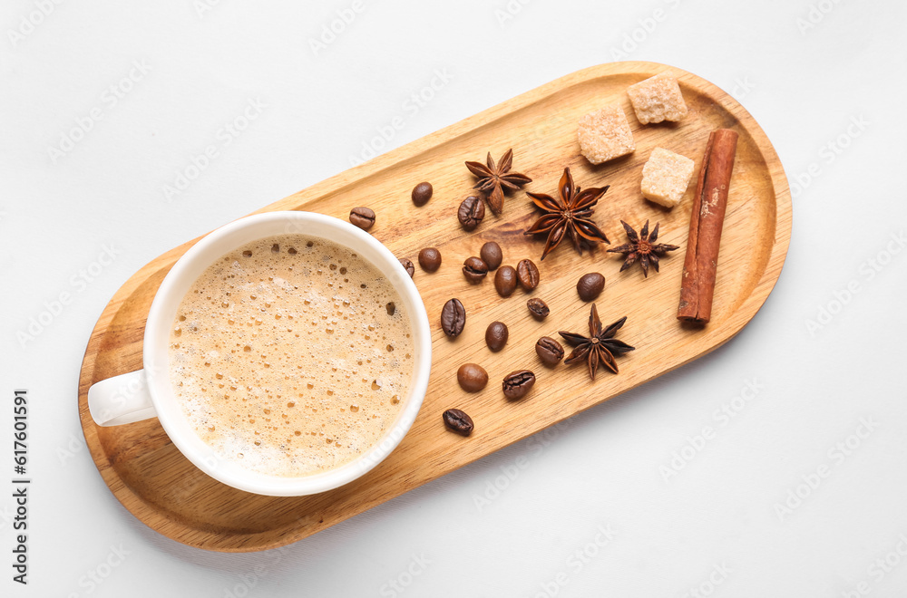 Board with cup of hot espresso and coffee beans on white background