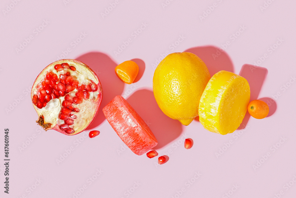 Solid colorful shampoo bars with lemon, kumquat and pomegranate on pink background