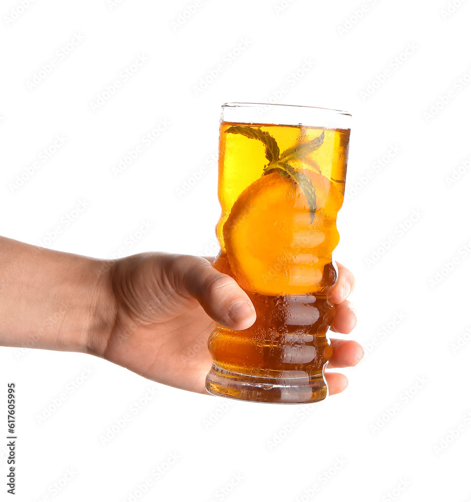 Female hand holding glass of ice tea with orange on white background