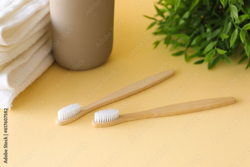 Bamboo tooth brushes on beige background