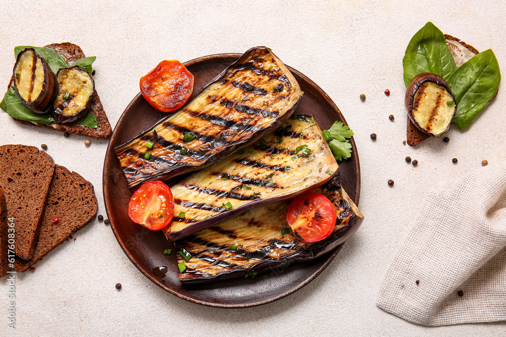 Composition with delicious grilled eggplants on light background