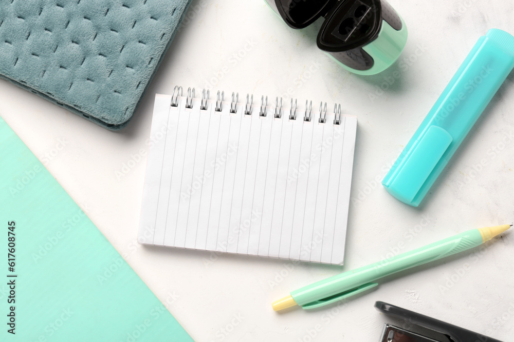 Notebooks with different school stationery on white background