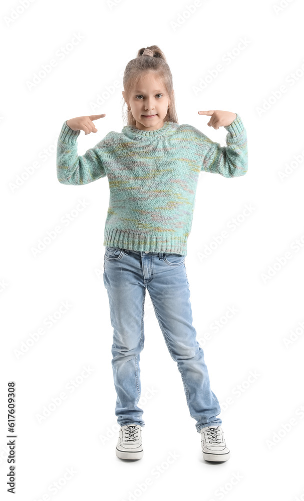 Cute little girl in knitted sweater pointing at herself on white background