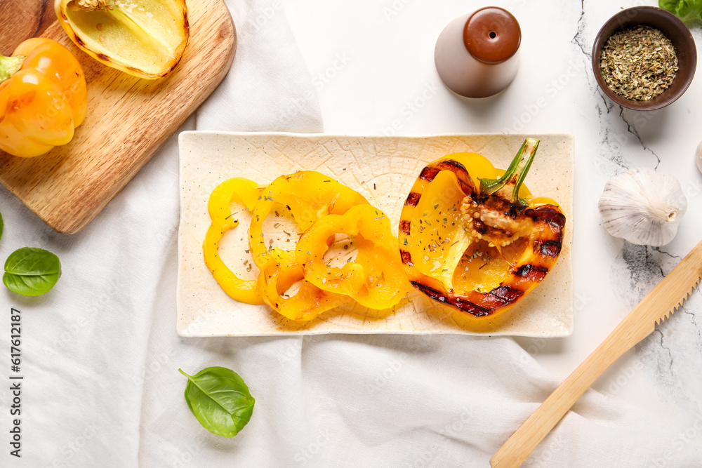 Plate with tasty grilled bell peppers on white marble background