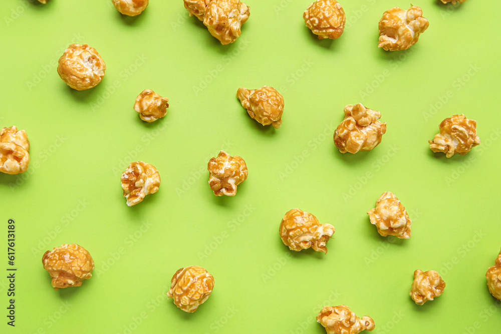 Tasty popcorn on green background