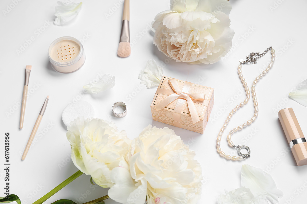 Composition with gift box, female accessories, cosmetics and peony flowers on white background