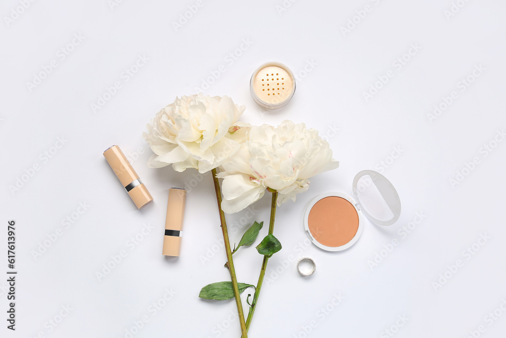 Composition with cosmetics and beautiful peony flowers on white background