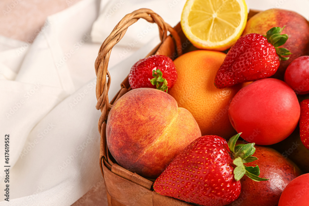 Wicker basket with different fresh fruits, closeup