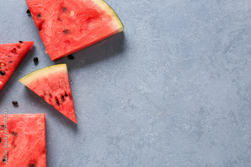 Pieces of fresh watermelon on blue background