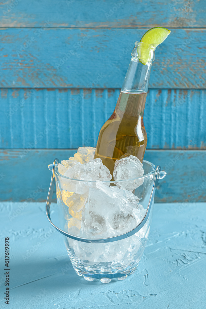 Bottle of cold beer with lime on table