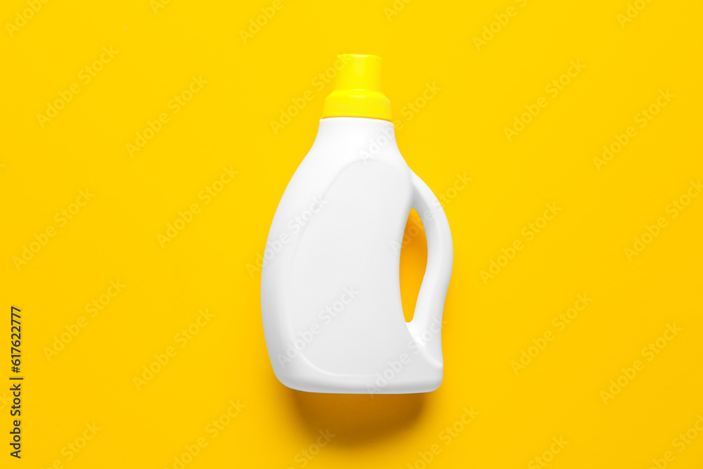 Bottle of detergent on orange background