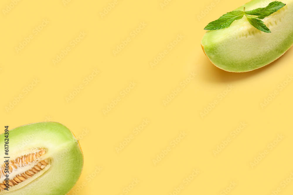 Pieces of sweet melon and mint on yellow background