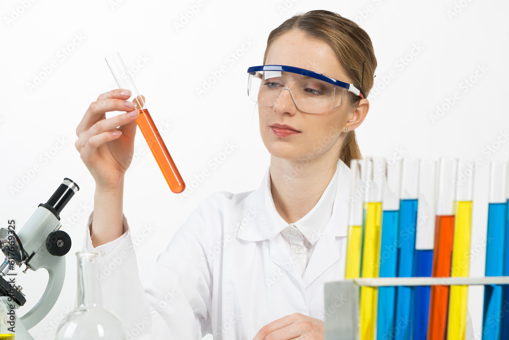 Beautiful woman scientist in protective goggles