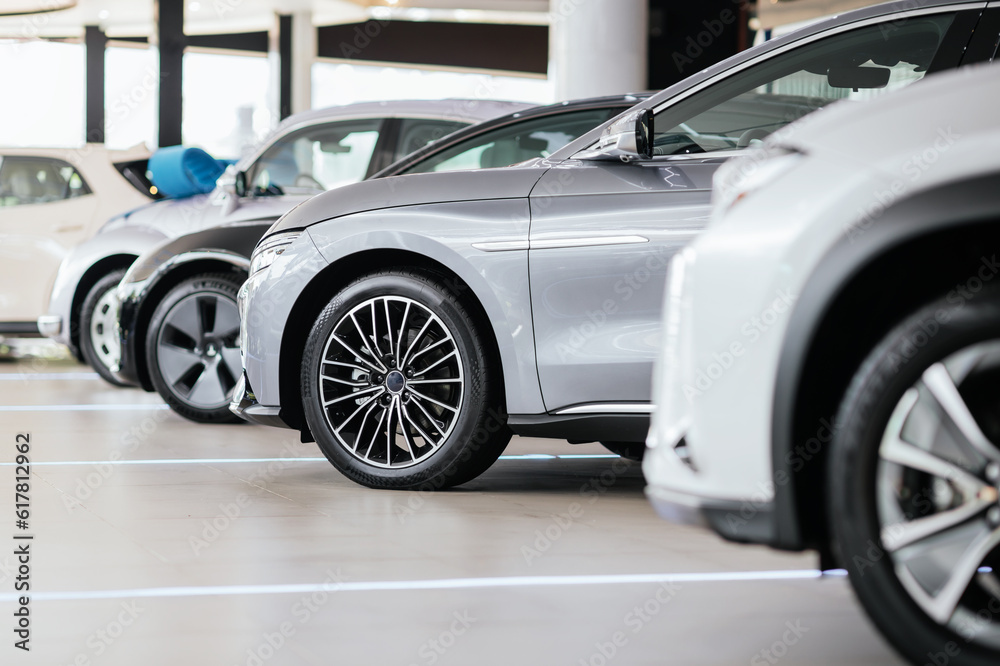 New cars in the showroom show waiting for sale to customer. Luxury modern cars for sale. Cars waitin