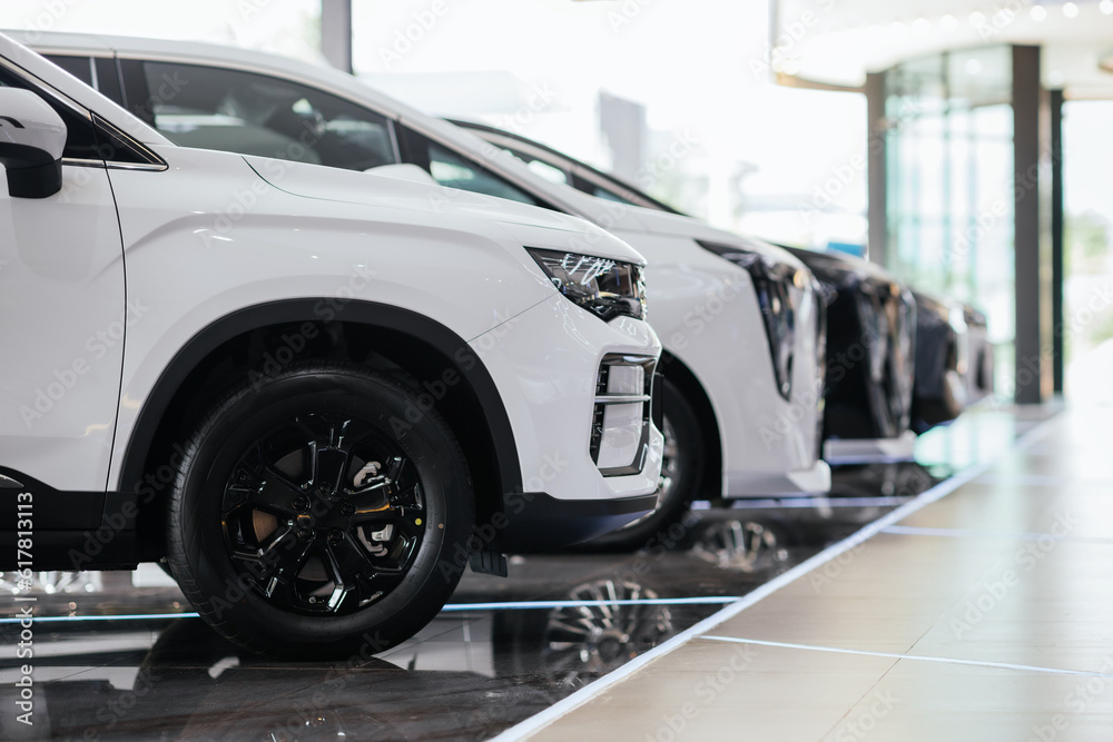 New cars in the showroom show waiting for sale to customer. Luxury modern cars for sale. Cars waitin