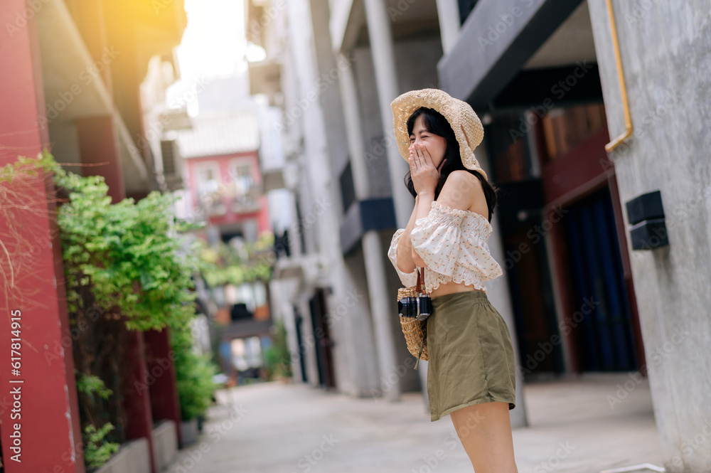 Happy youth asian woman with camera travels street city trip on leisure weekend. Young hipster femal