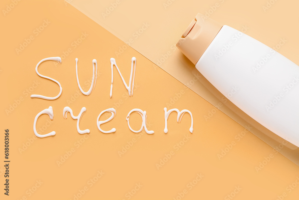 Text SUN CREAM with bottle on color background