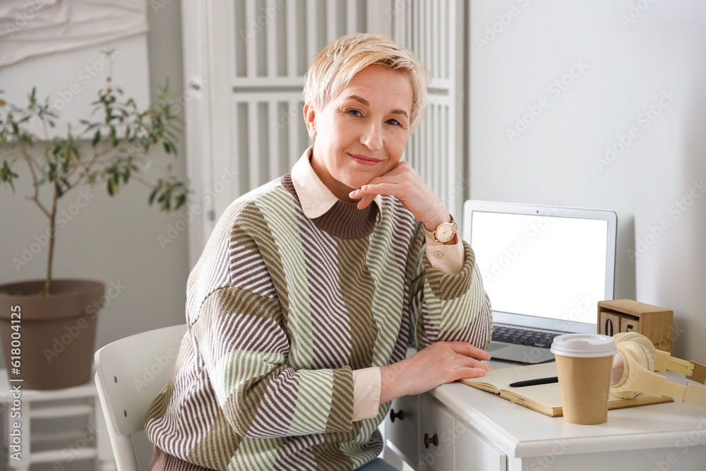 Thoughtful mature woman working at home