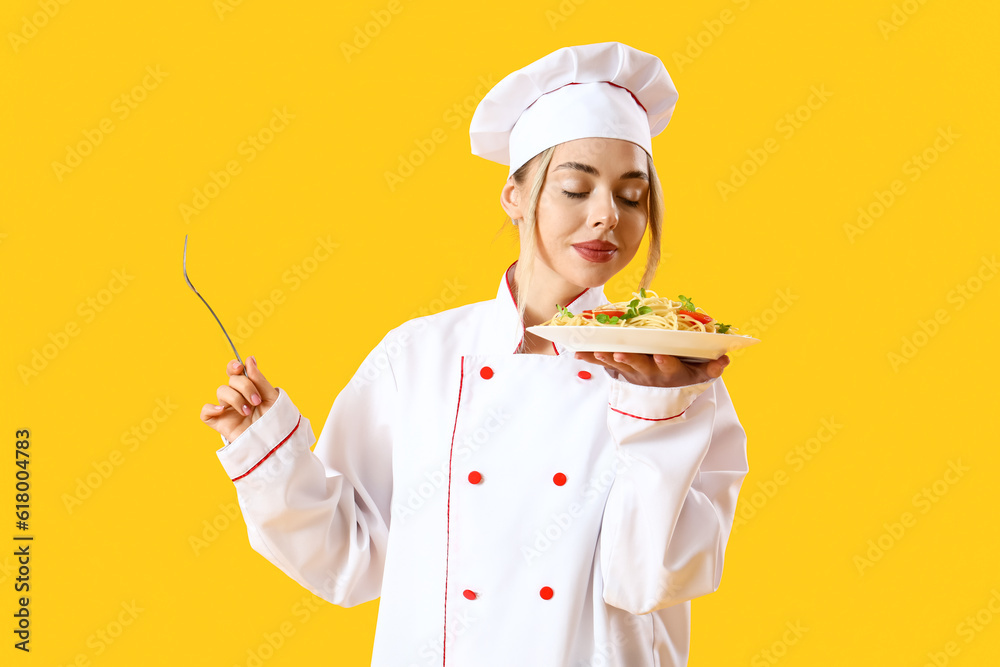 Female chef with tasty pasta on yellow background