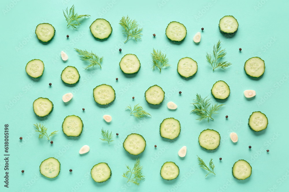 Slices of cucumber with dill and garlic on turquoise background